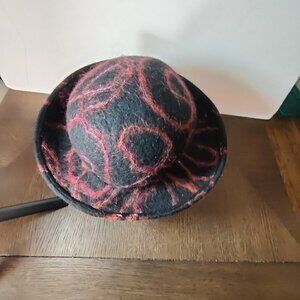Hat, felt wool by designer Miriam Carter. Black woolen with cranberry accents. M